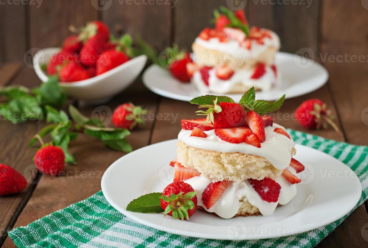 Sponge cake with cream and strawberries photo