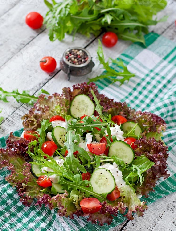 Useful dietary salad with cottage cheese, herbs and vegetables photo