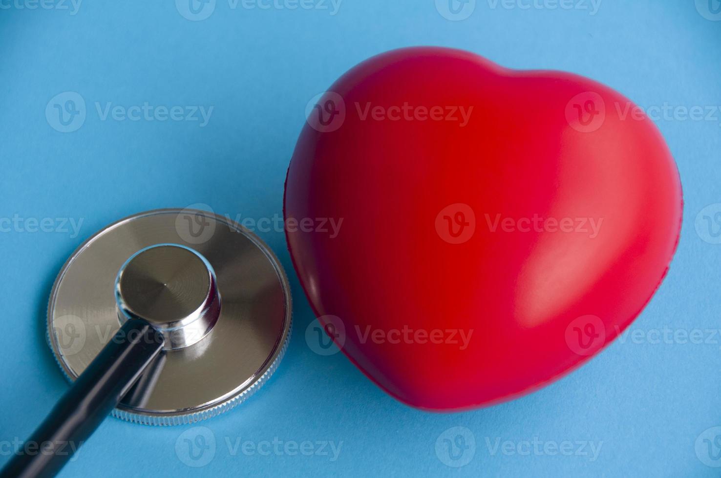 Stethoscope with heart shapes on light blue background. Health concept photo