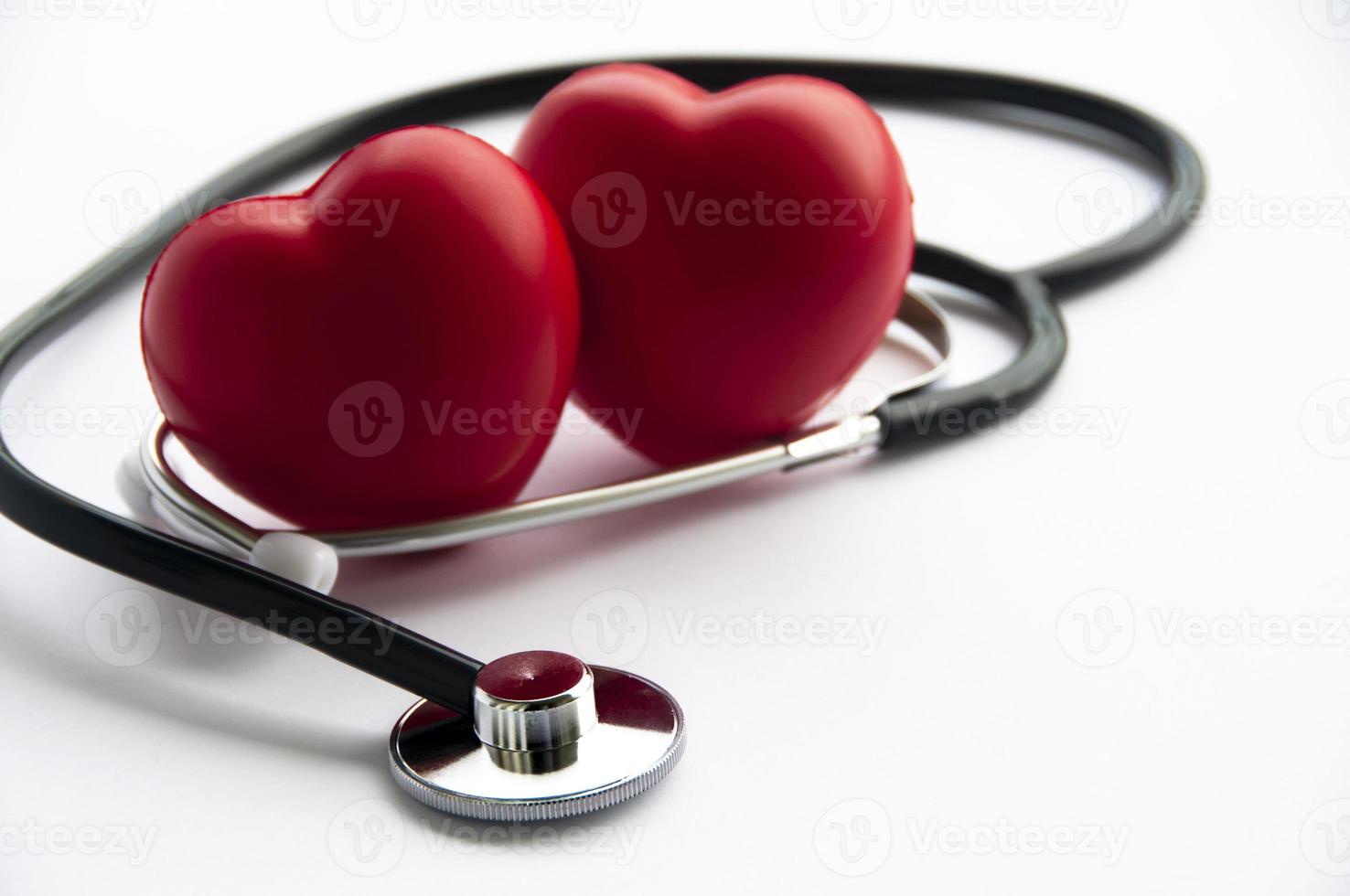 Stethoscope with two heart shapes on white background. Copy space and health concept photo