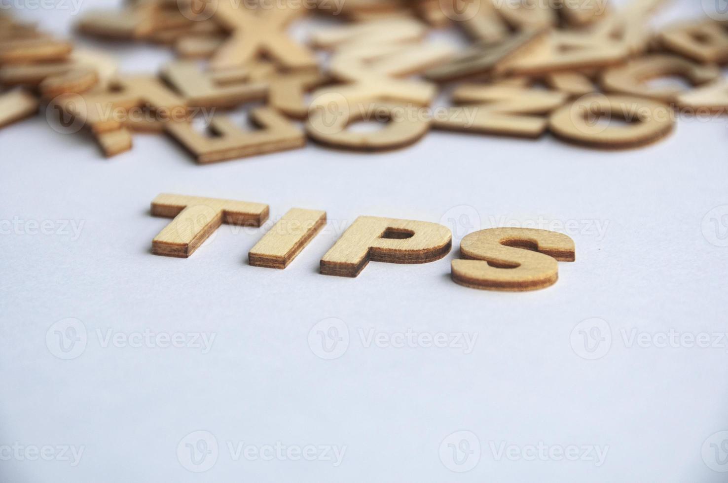 Tips wooden text on while cover background. Tips concept photo