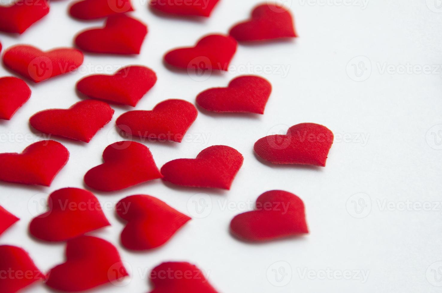 Red heart shapes on white background customizable with space for text. Copy space and relationship concept photo