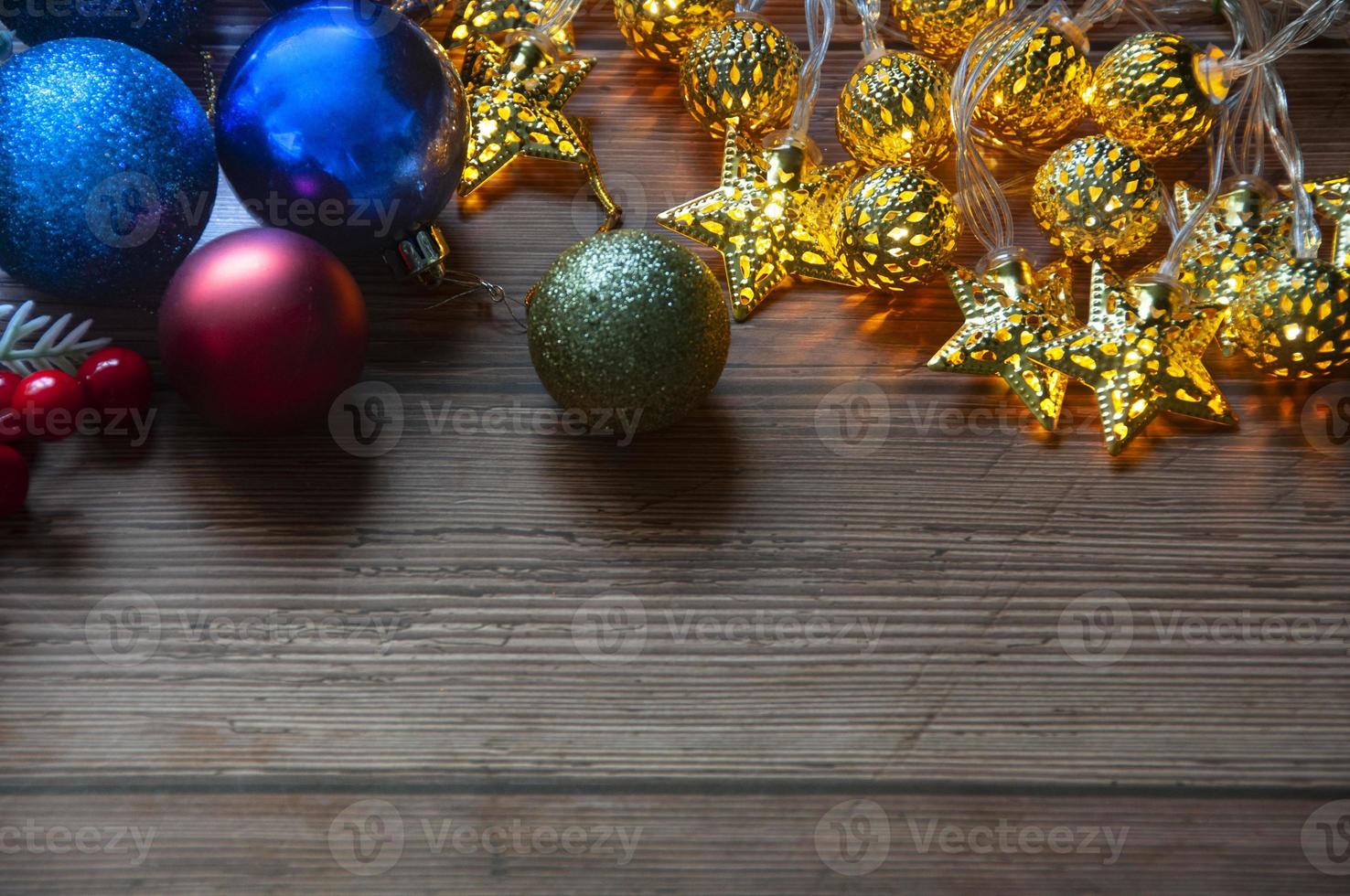 Christmas light and decorations on wooden table background with customizable space for text. Copy space. photo