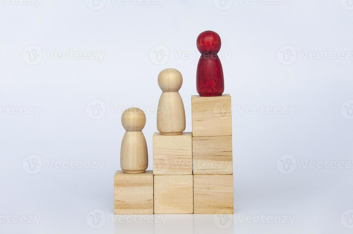 Wooden red and other people figure on top of wooden blocks. Goal achievement, business growth and career progression concept. Copy space. photo