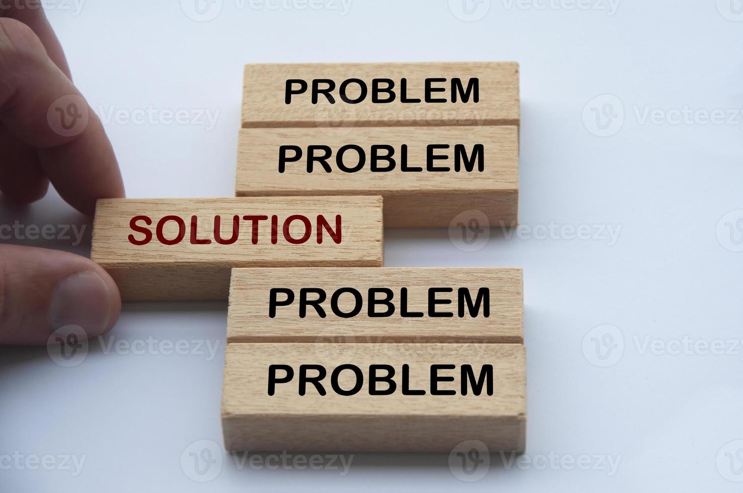 Hand putting wooden block with word solution in the middle of wooden blocks with words problem. Solution concept photo