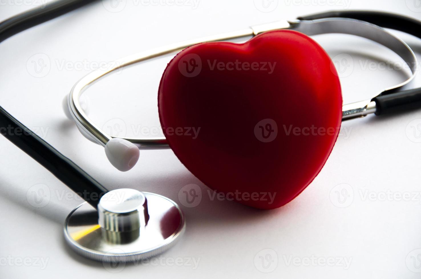 Stethoscope with heart shape on white background. Copy space and health concept photo