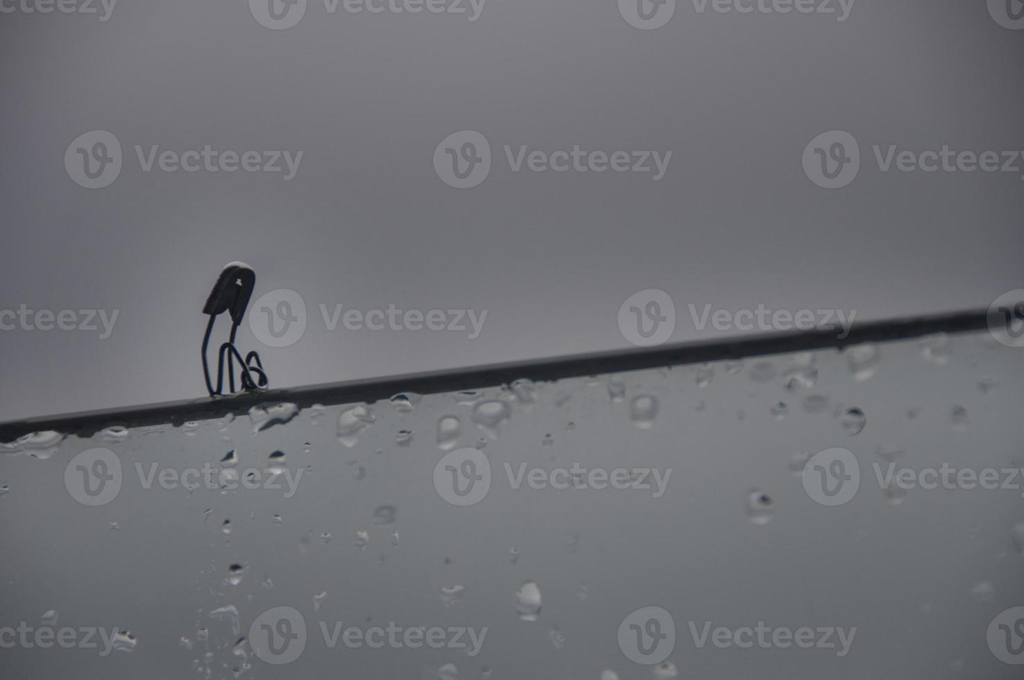 Lonely safety pin sitting on glass wall with customizable space for text and ideas. Lonely concept photo