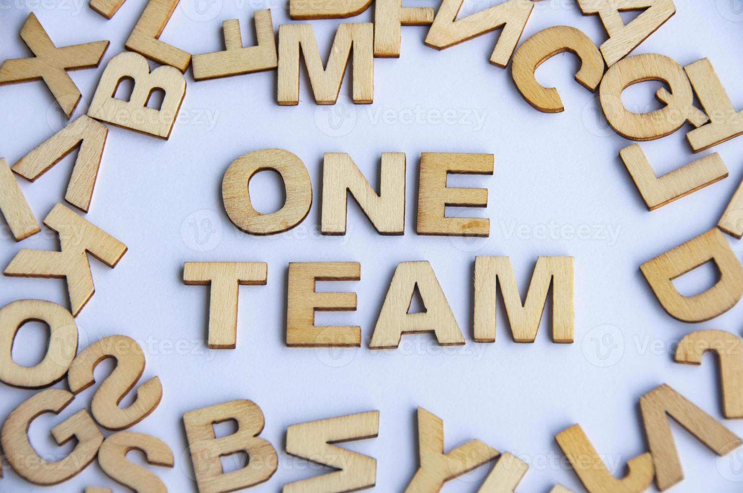 One team wooden text on while cover background. Teamwork concept photo