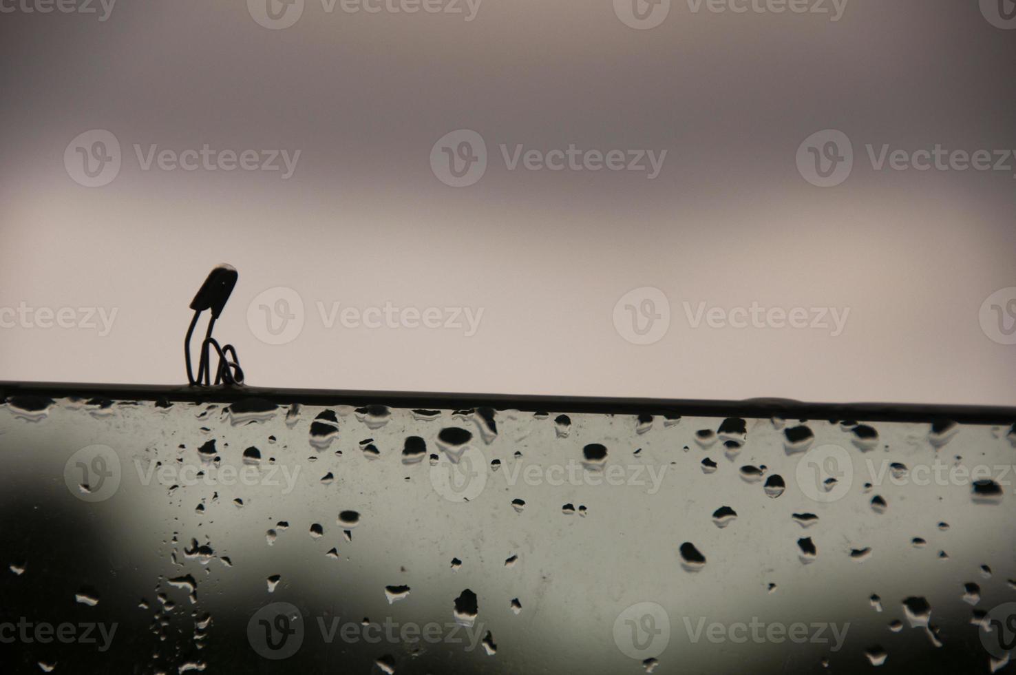 Lonely safety pin sitting on glass wall with customizable space for text and ideas. Lonely concept photo