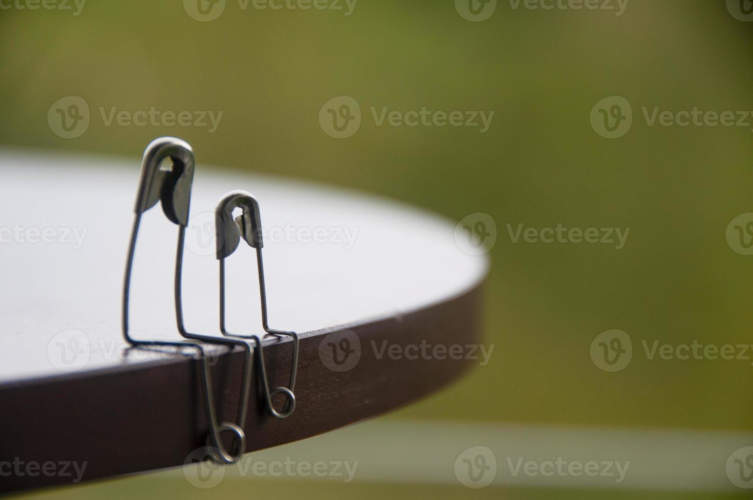 Model safety pin of parent and children sitting on wooden table with customizable space for text or ideas. Family concept photo