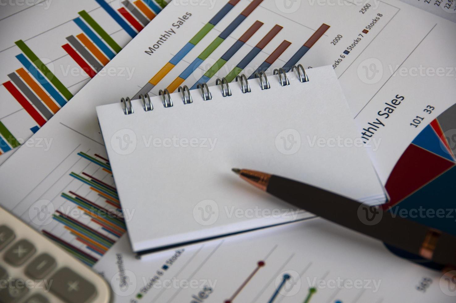 Blank notepad with customizable space for text with graph analysis background. Copy space and business analysis concept photo