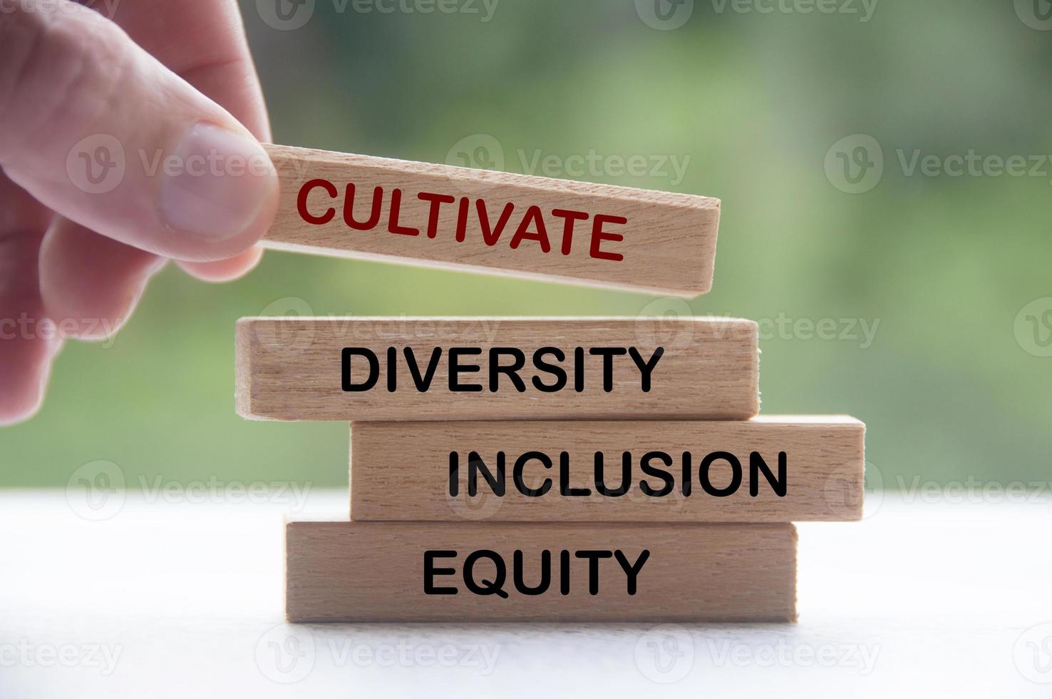 Hand holding wooden block with text - Cultivate diversity, inclusion and equity. Business culture concept photo