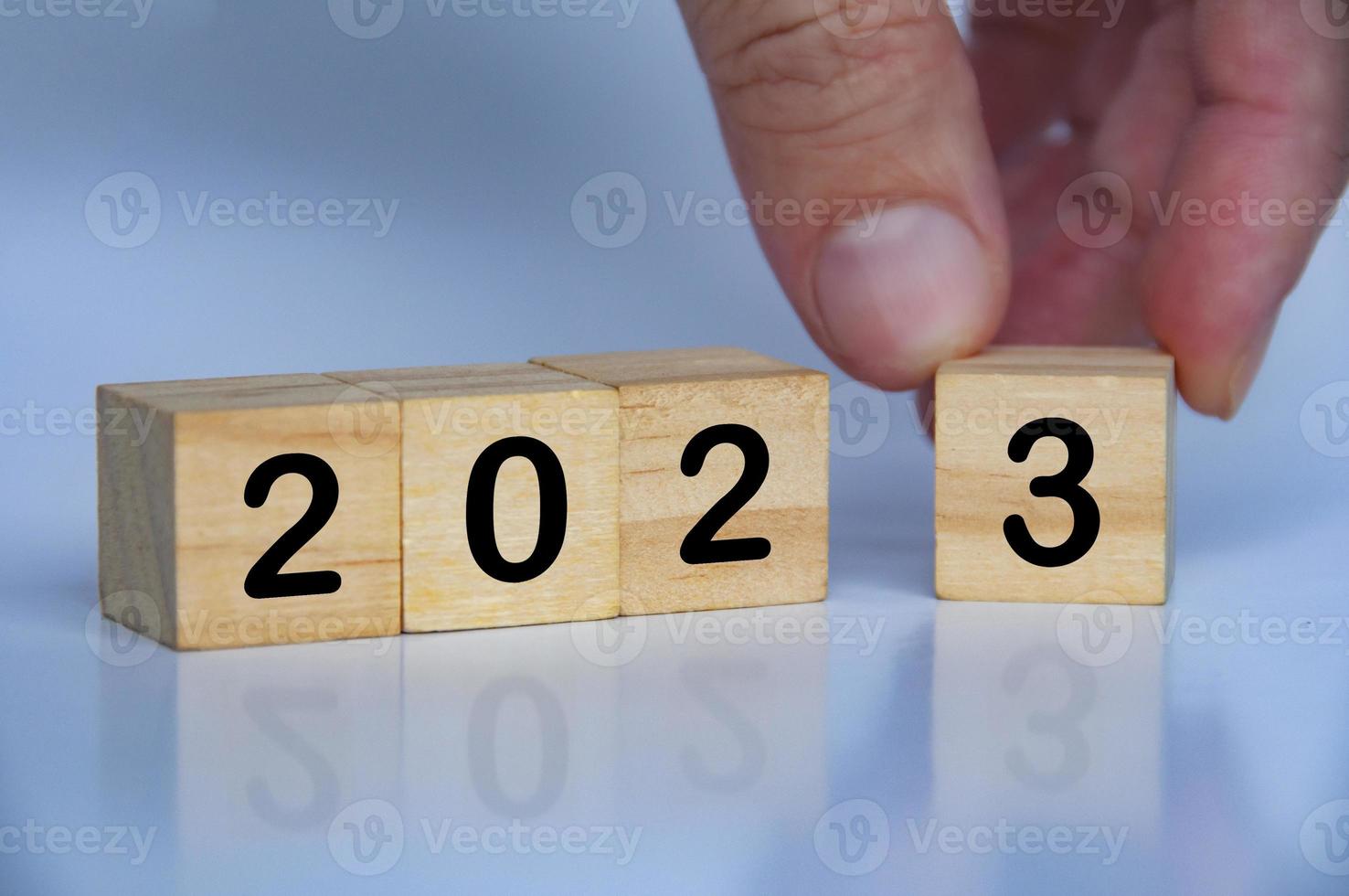 2023 text on wooden blocks with hand background. New year concept photo