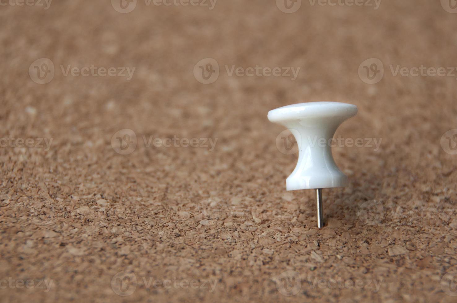 White push pins pinned on wooden background. Copy space. photo