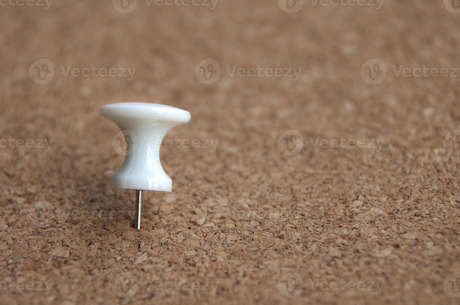 White push pins pinned on wooden background. Copy space. photo