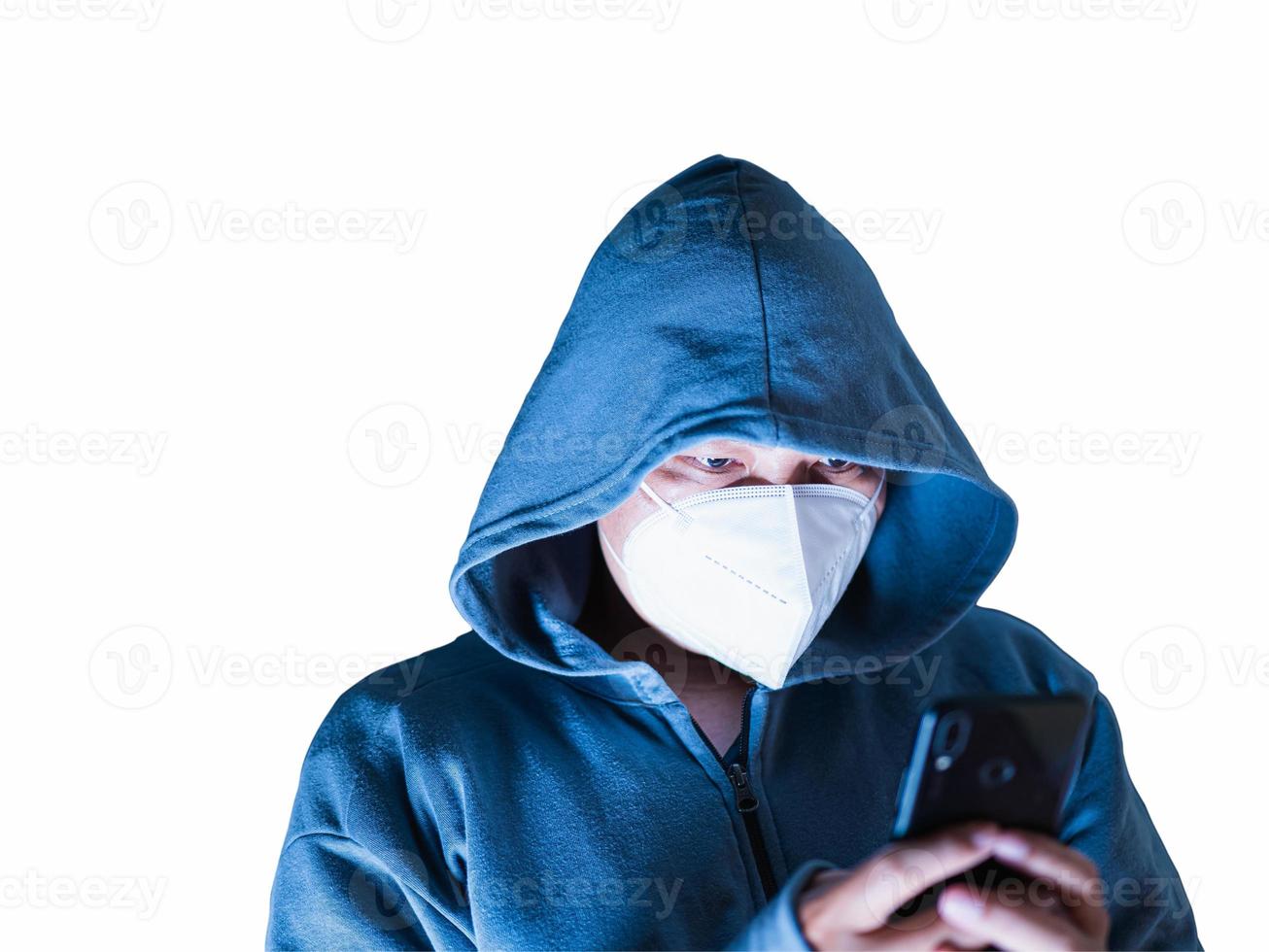Asian man in hoodie and mask hacking Something from mobile phone in white background with clipping path photo