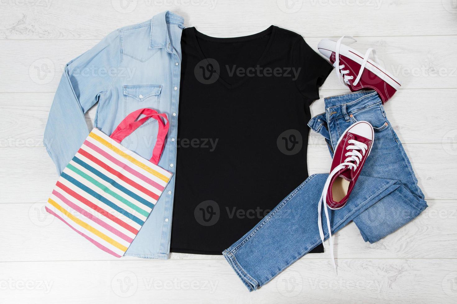 T shirt black and sneakers. T-shirt Mockup flat lay with summer accessories. Bag, jeans and sneakers on wooden floor background. Copy space. Template blank canvas. Front top view. photo