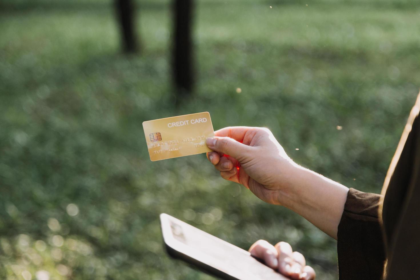 Hands holding credit card and using laptop. Online shopping photo
