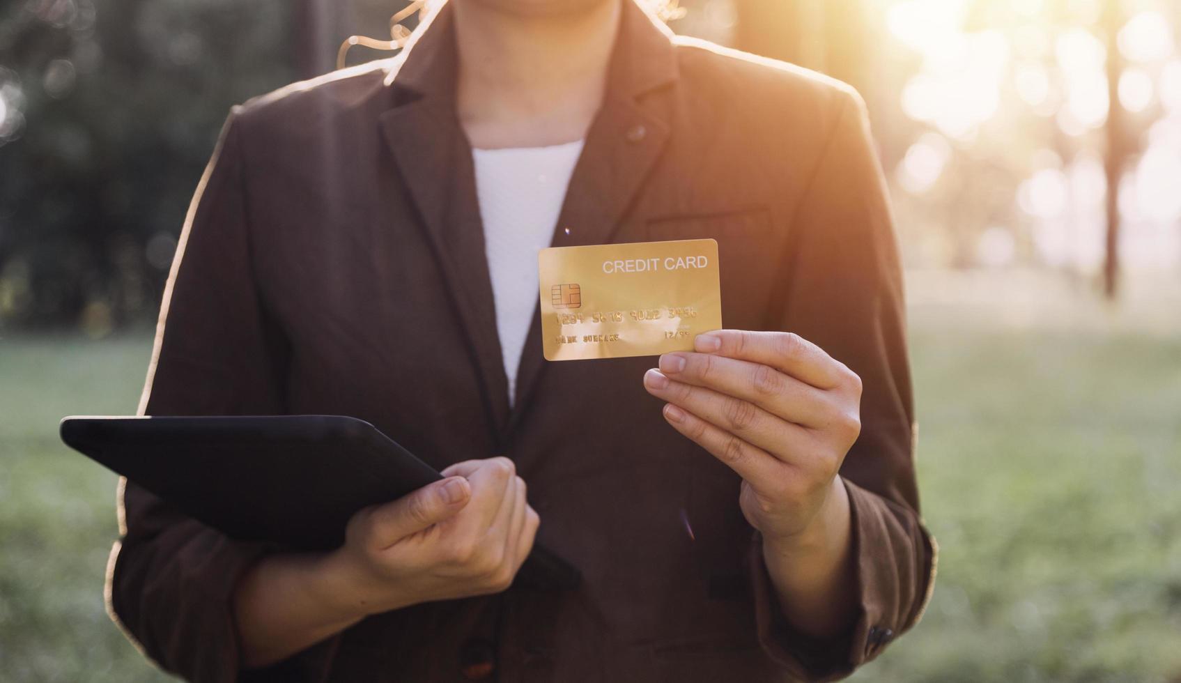Hands holding credit card and using laptop. Online shopping photo