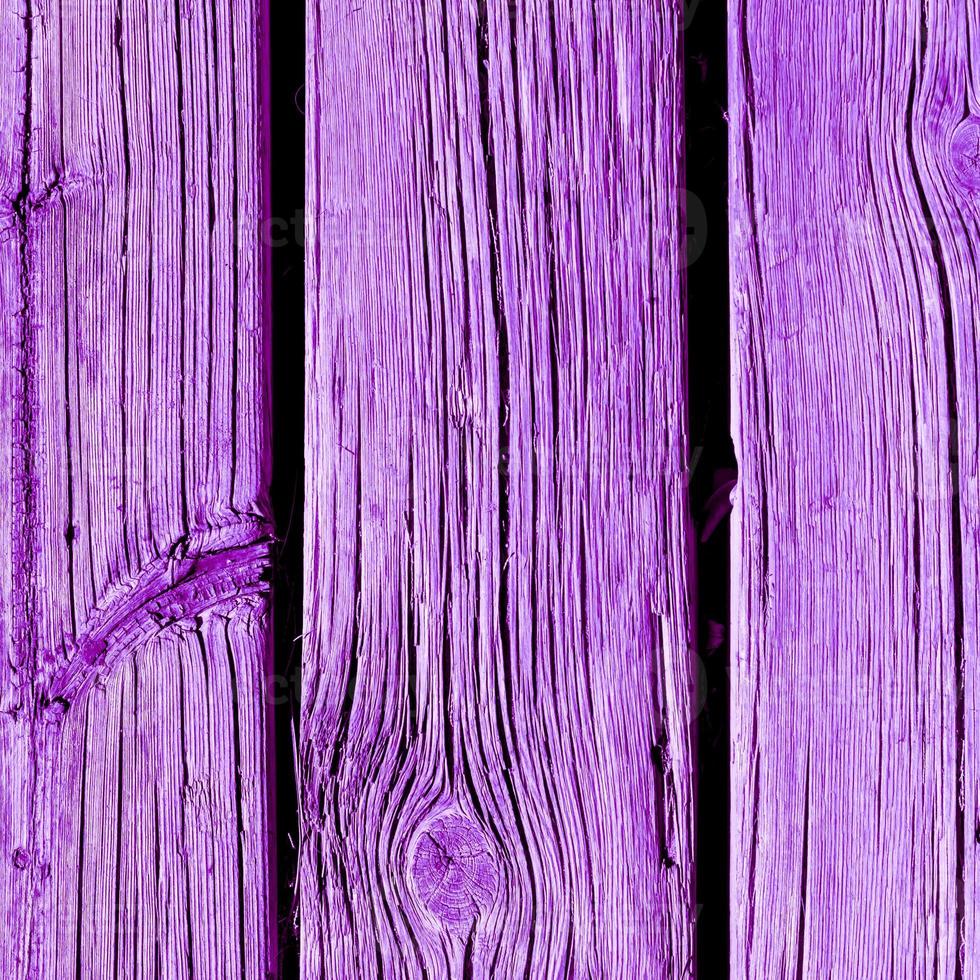 Weathered wooden plank painted in proton purple photo