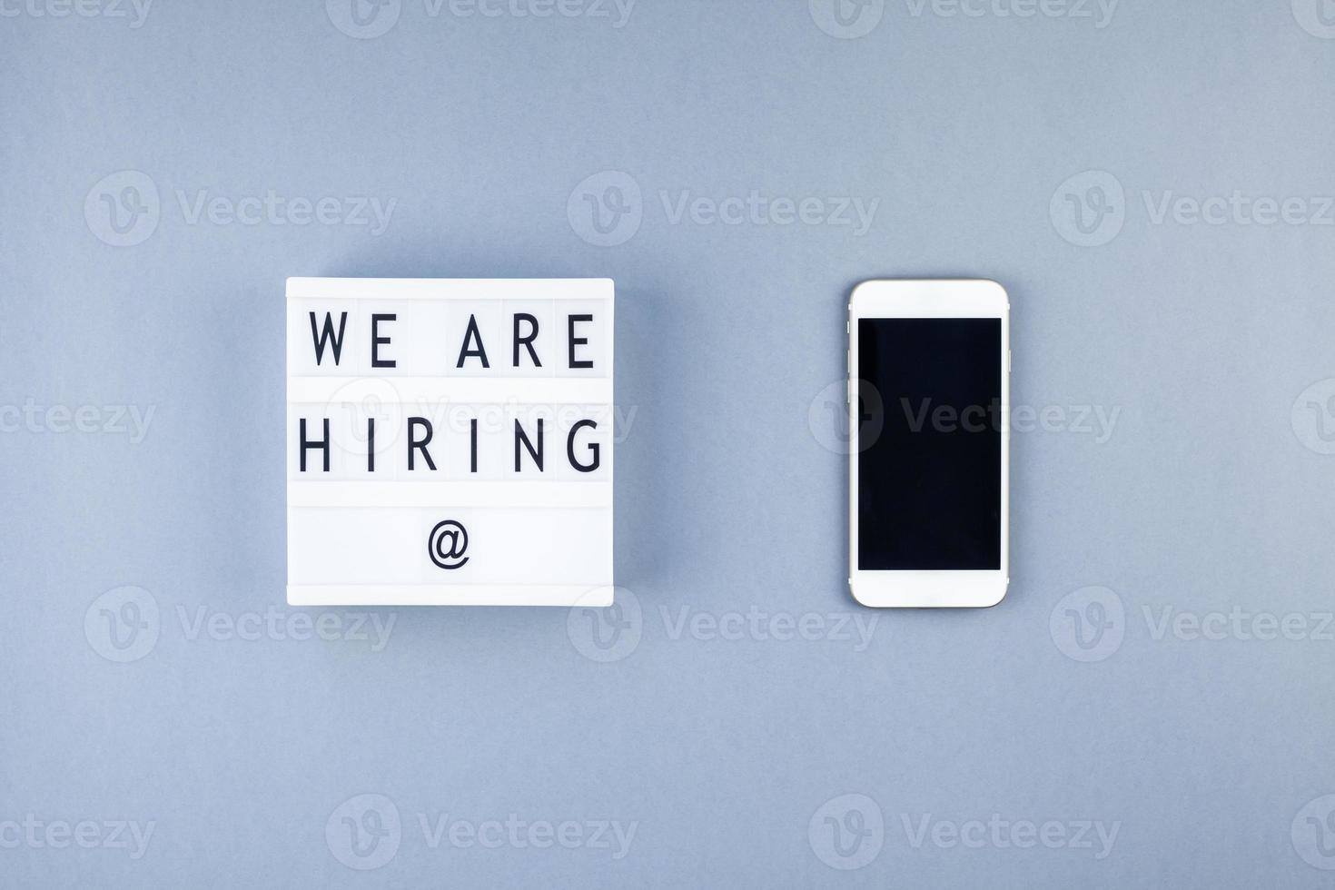 We are hiring flat lay on blue background photo