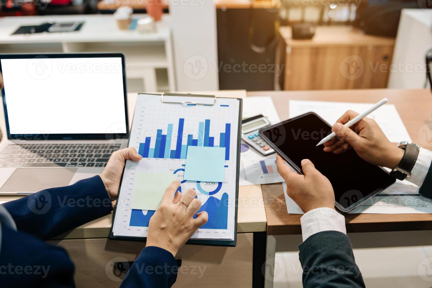 Team business meeting presentation. Hand businessman working project in modern office.Laptop computer and tablet and smart phone on white desk in morning light photo