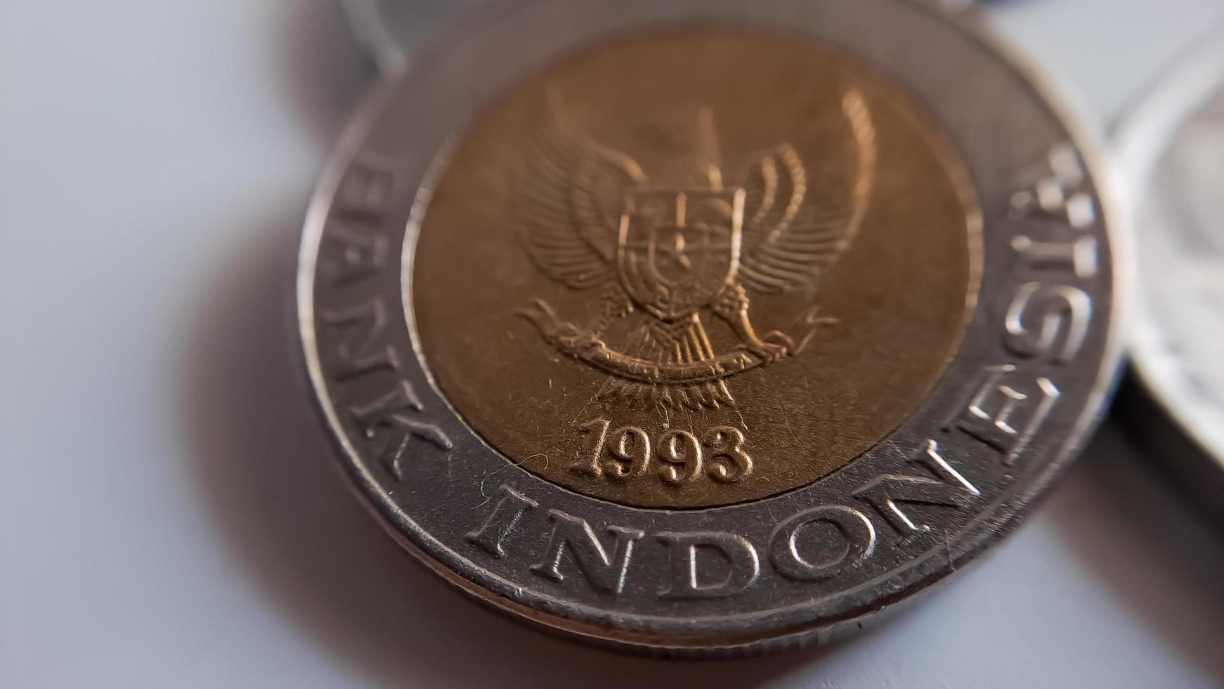 One thousand rupiah coin from Indonesia with the palm oil symbol isolated on white background, Diterbitkan oleh bank Indonesia pada tahun 1993 photo