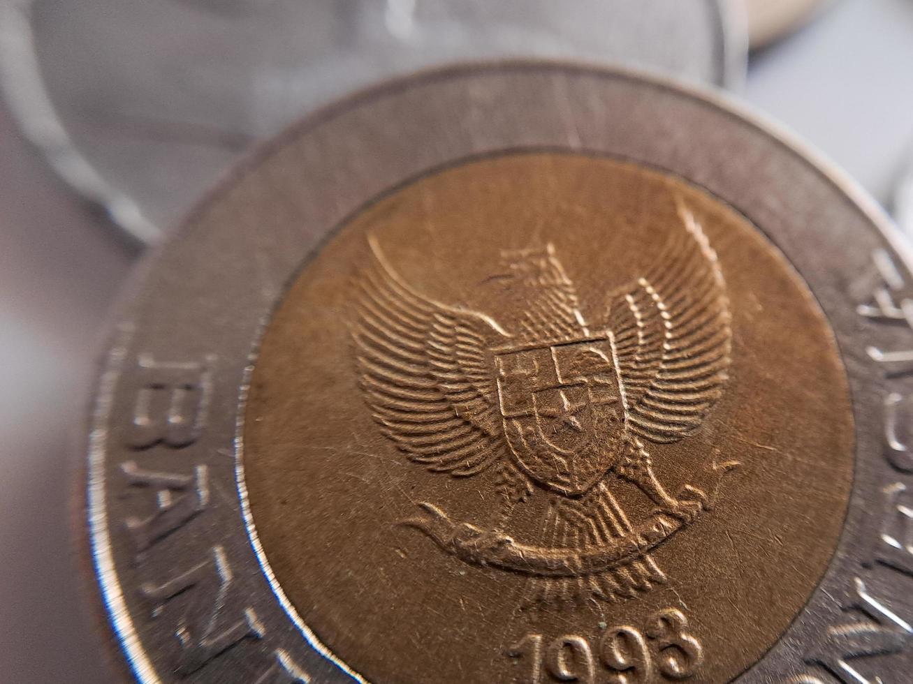 One thousand rupiah coin from Indonesia with the palm oil symbol isolated on white background, Diterbitkan oleh bank Indonesia pada tahun 1993 photo