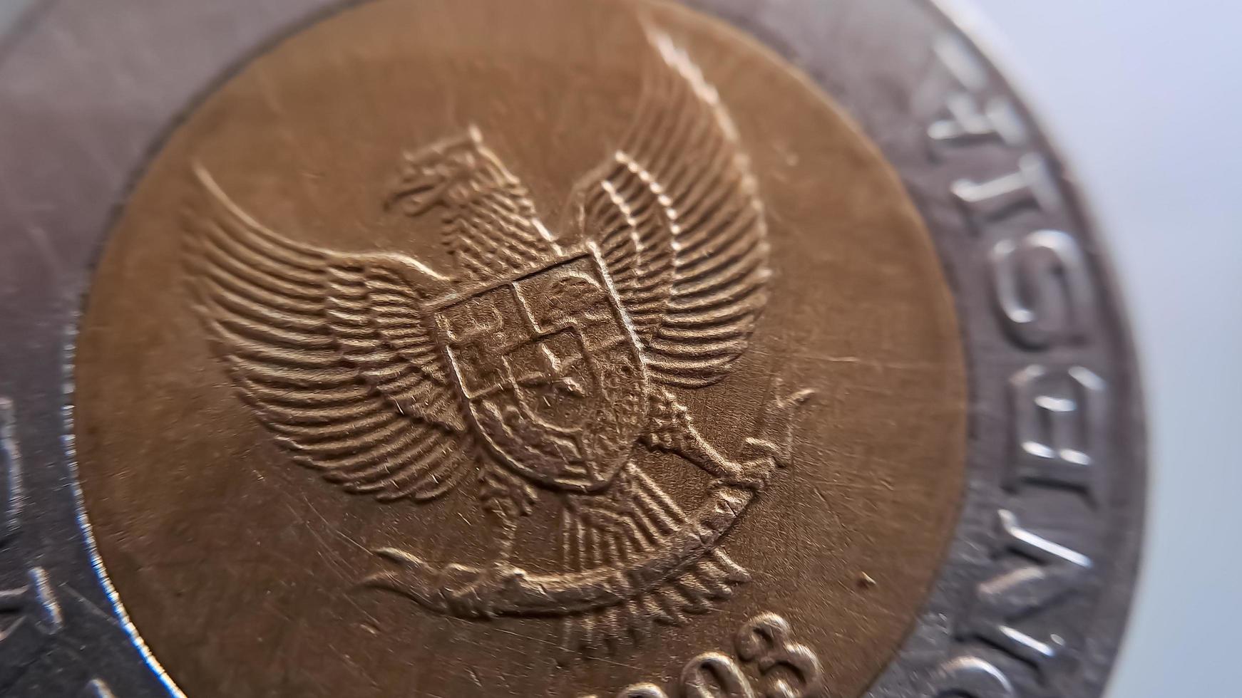 One thousand rupiah coin from Indonesia with the palm oil symbol isolated on white background, Diterbitkan oleh bank Indonesia pada tahun 1993 photo