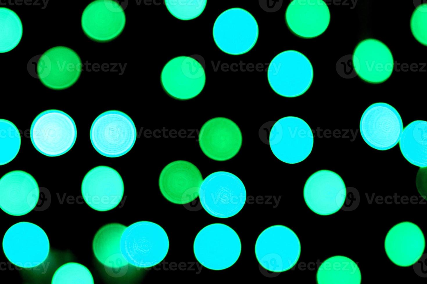 Unfocused abstract colourful bokeh black background. defocused and blurred many round blue light photo