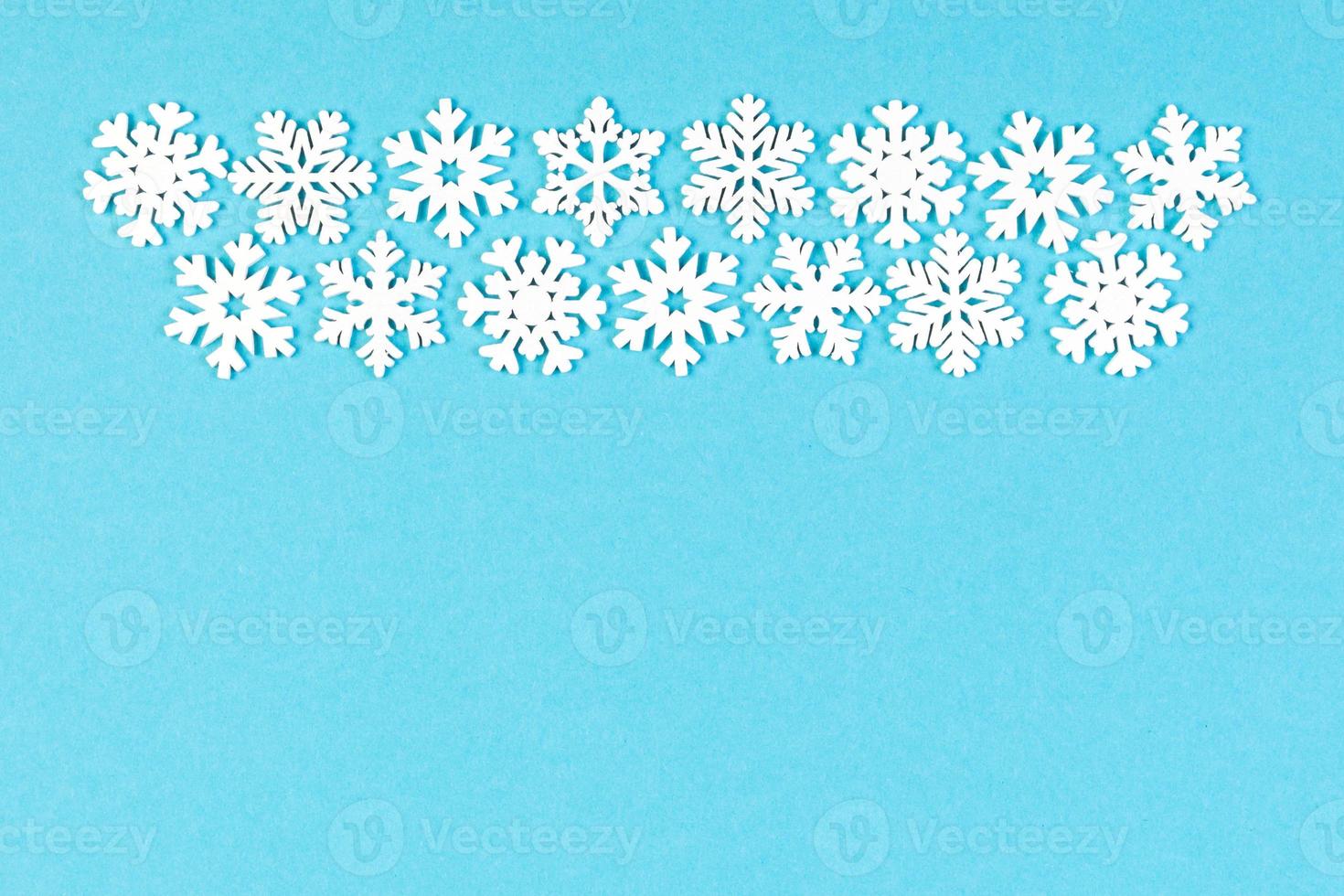 Set of white snowflakes on colorful background. Top view of Christmas ornament. New Year time concept with empty space for your design photo