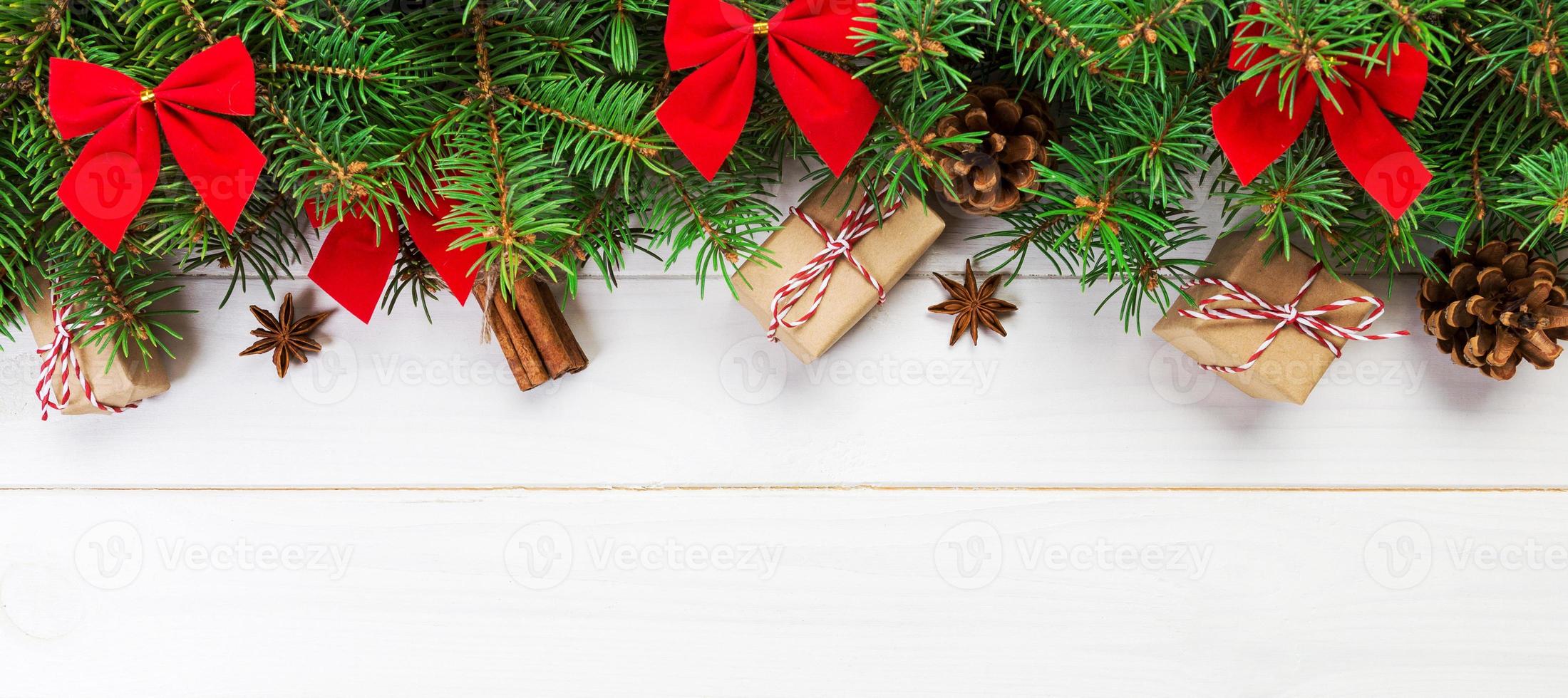 Christmas background with fir tree and gift box on wooden table. Top view with banner copy space for your design photo