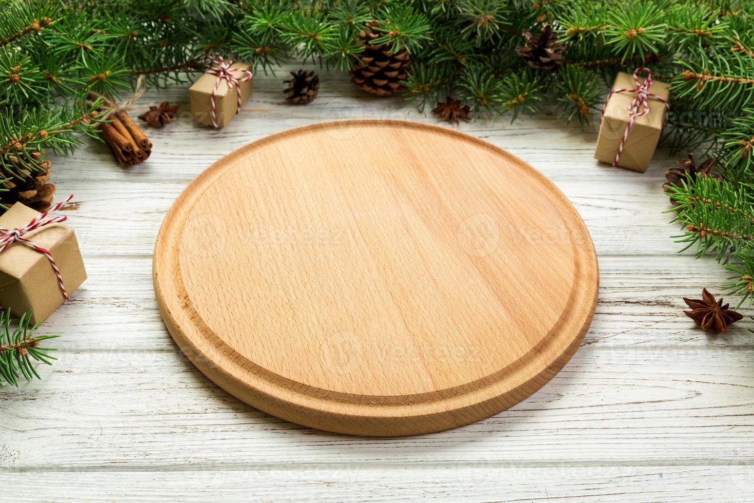 Perspective view. Empty wood round plate on wooden christmas background. holiday dinner dish concept with new year decor photo