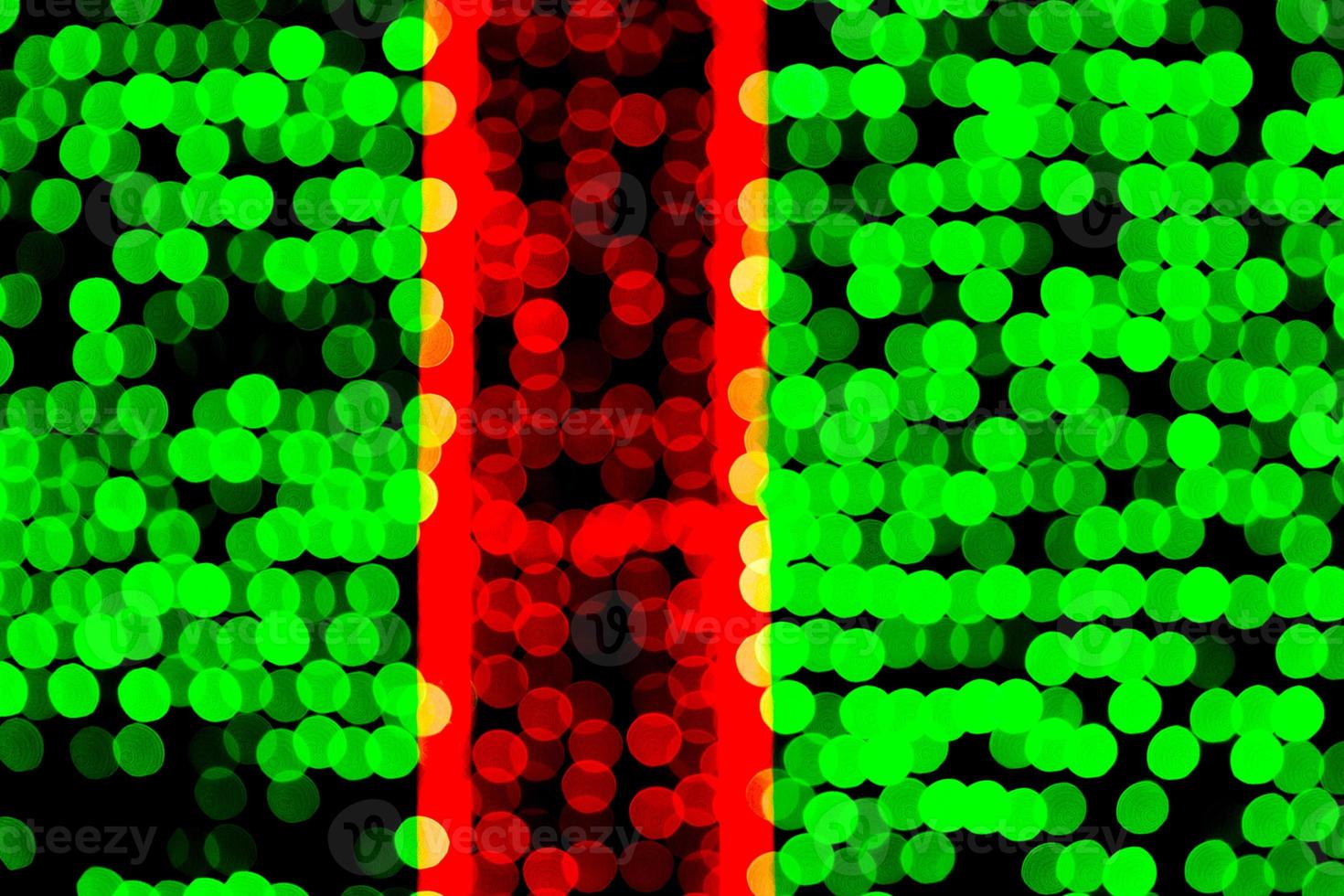 Unfocused abstract green and red bokeh on black background. defocused and blurred many round light photo