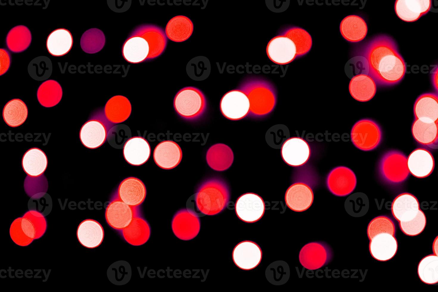 Unfocused abstract red bokeh on black background. defocused and blurred many round light photo