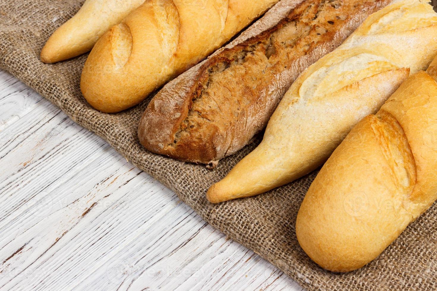 Homemade baguettes on wooden table. close up photo