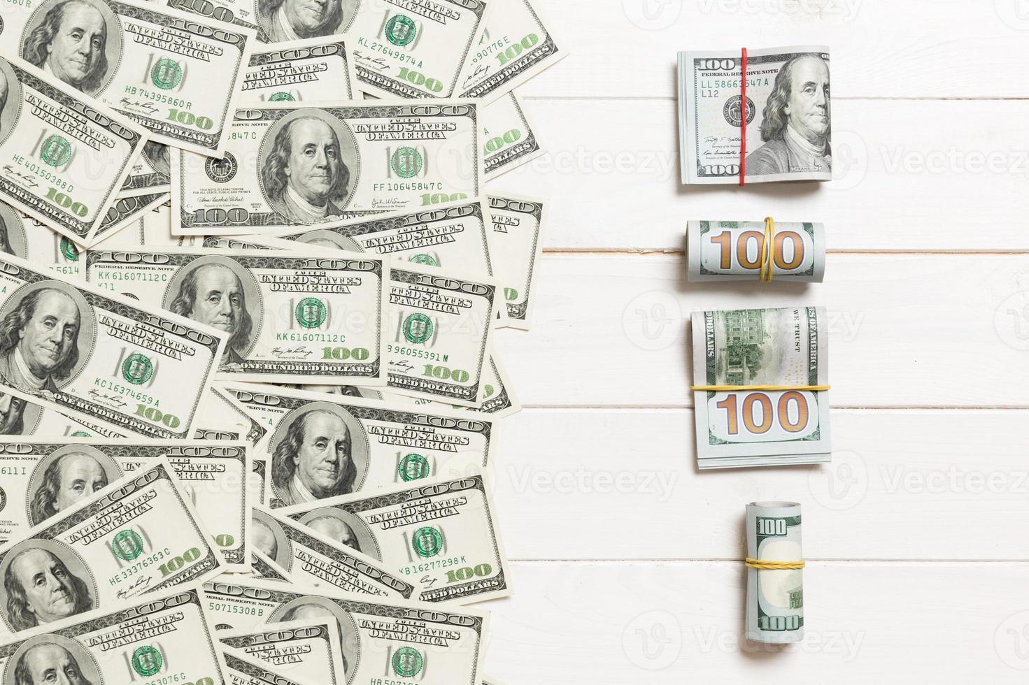 dollars currency on colored background top view, with empty place for your text business money concept. One hundred dollar bills with stack of cash photo