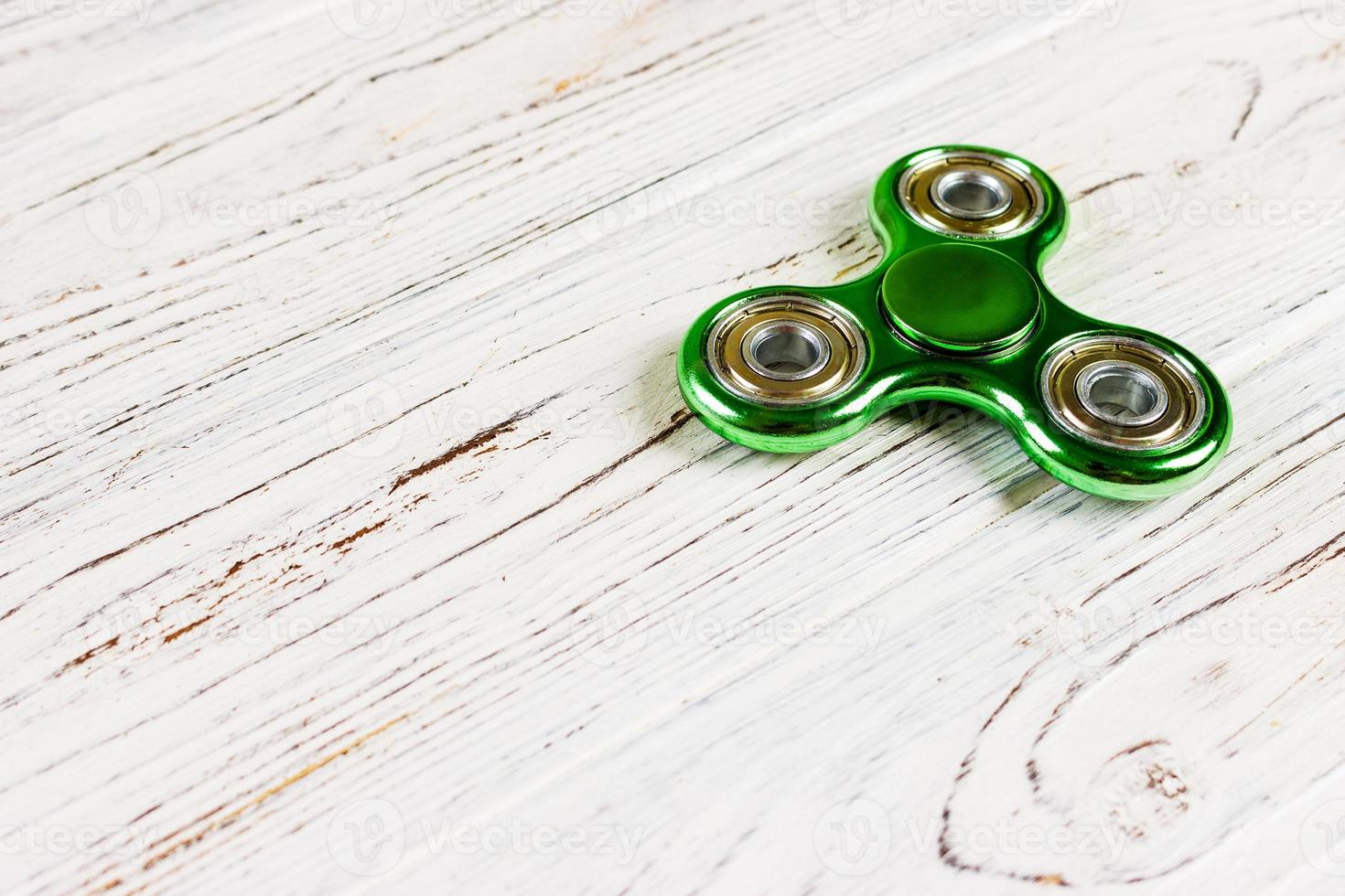Close up shot of an green fidget spinner photo