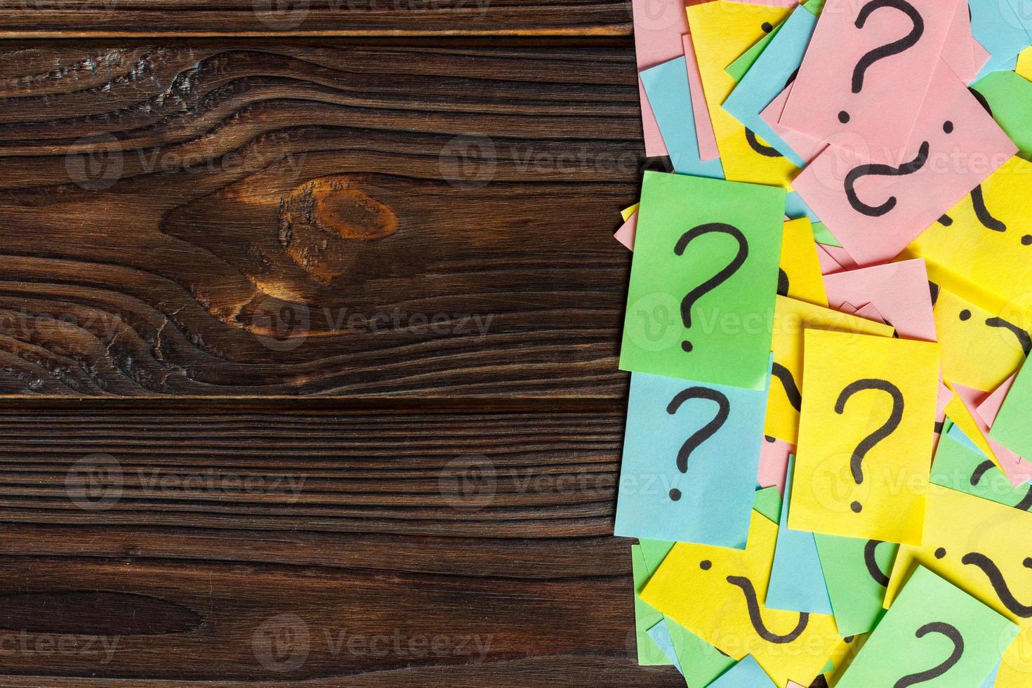 Concept for confusion, question or solution. question mark on wooden background photo