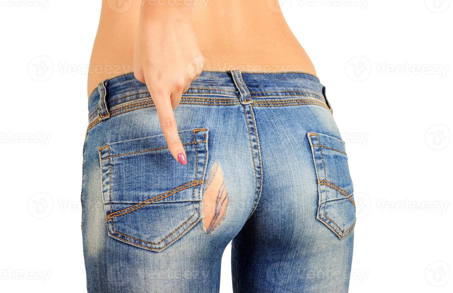 the girl shows a finger hole on the pope in old torn jeans. isolated photo