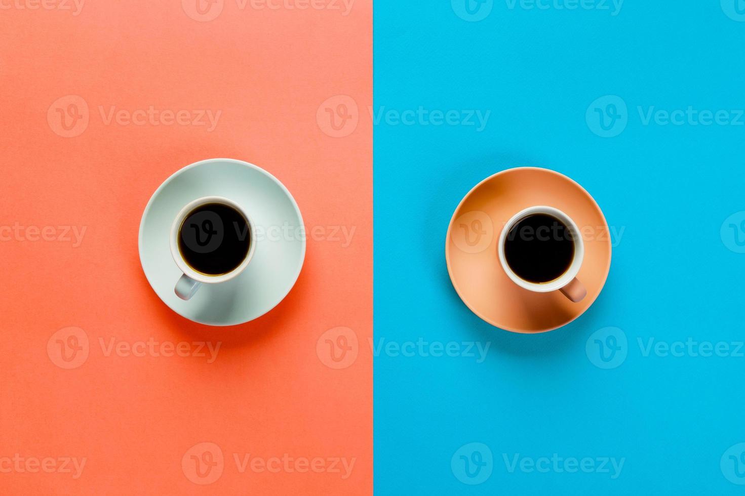 Blue and brown cup of coffee on a colorful orange and blue background. top view with copy space. morning concept photo