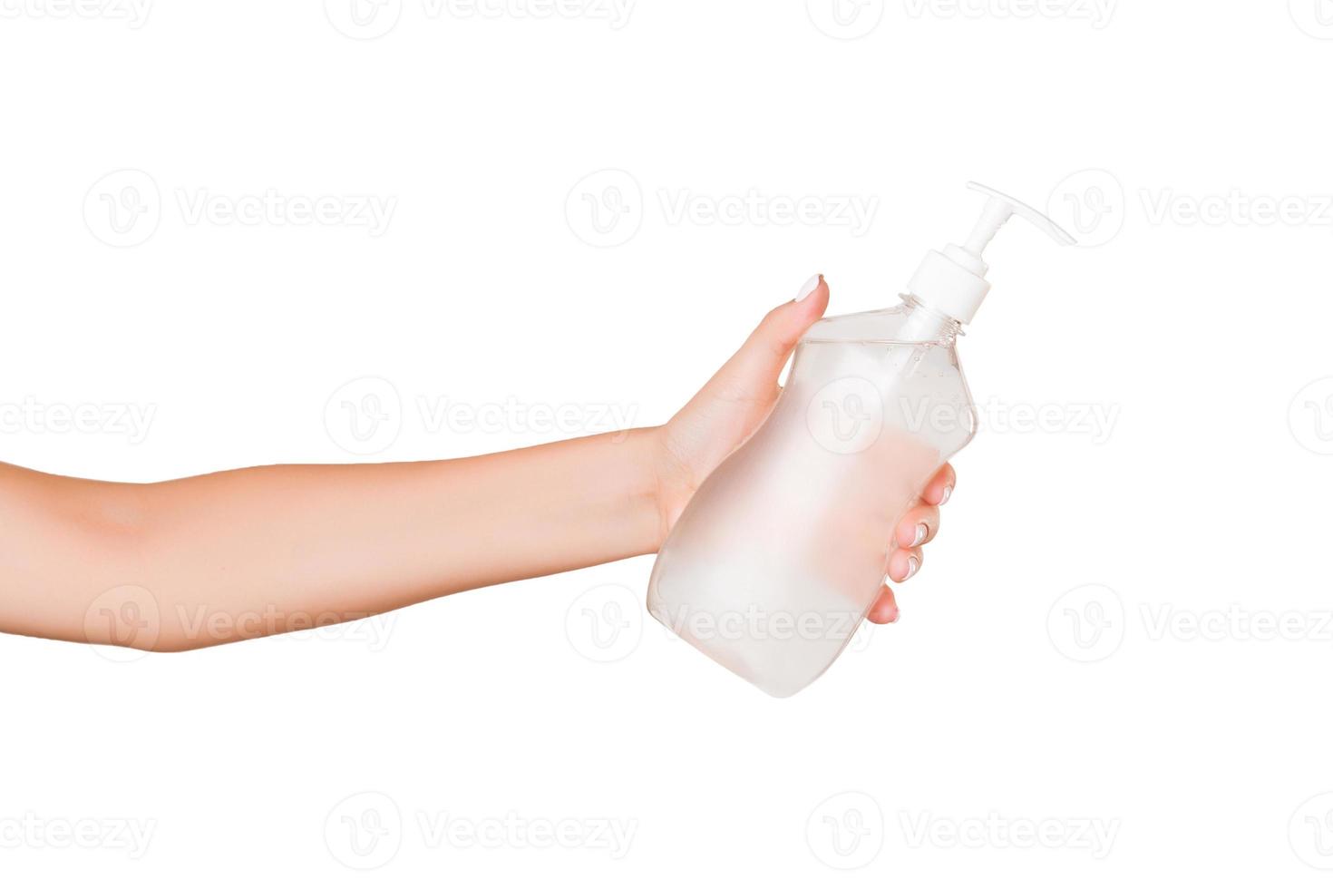 Female hand holding cream bottle of lotion isolated. Girl give cosmetic products on white background photo