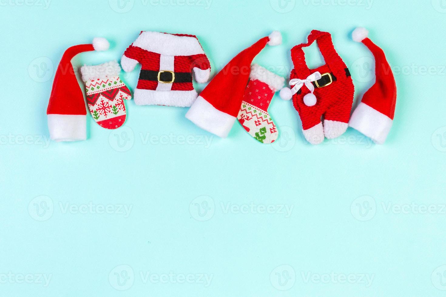 Top view red Santa hats on colorful background. Time for holiday concept with empty space for your design photo