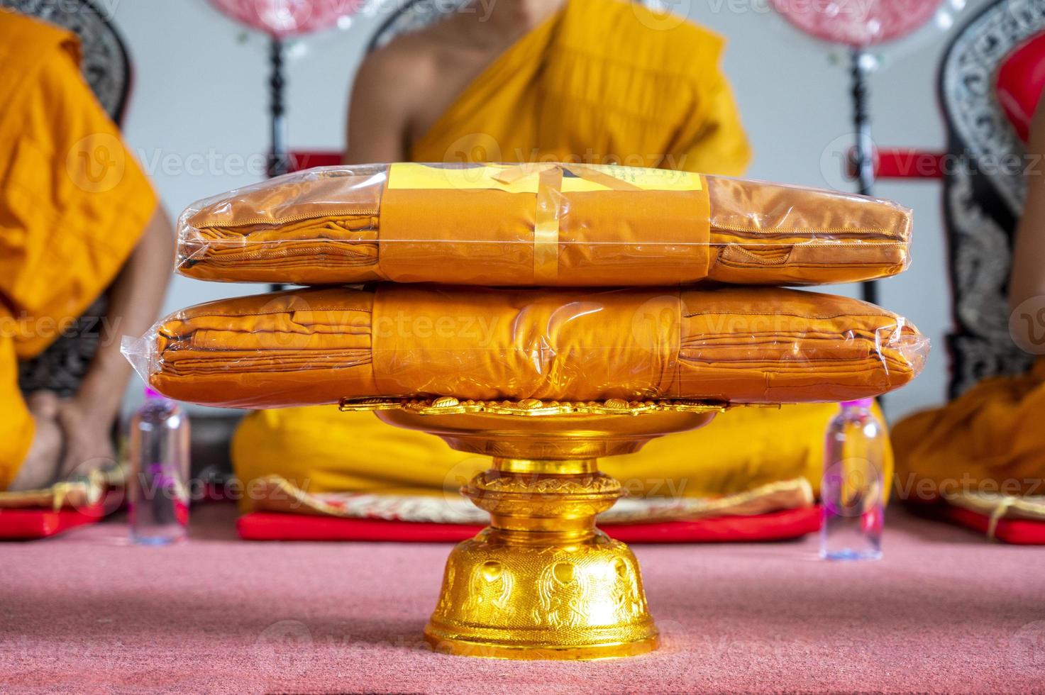 set of monk's robes placed on the pedestal photo