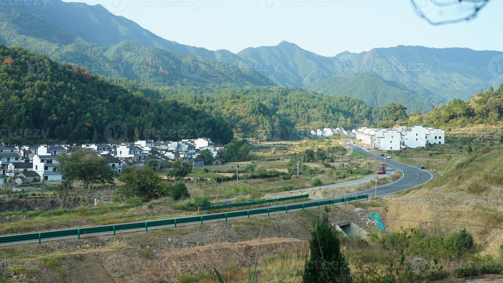 The beautiful traditional Chinese village view with the classical architecture and fresh green trees as background photo