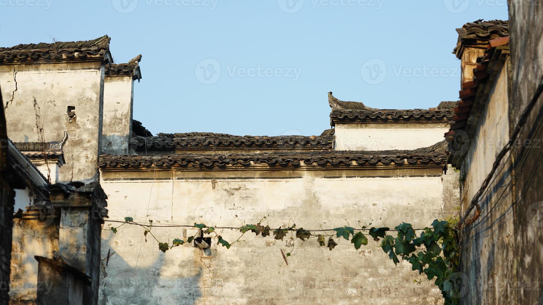 The beautiful traditional Chinese village view with the classical architecture and fresh green trees as background photo