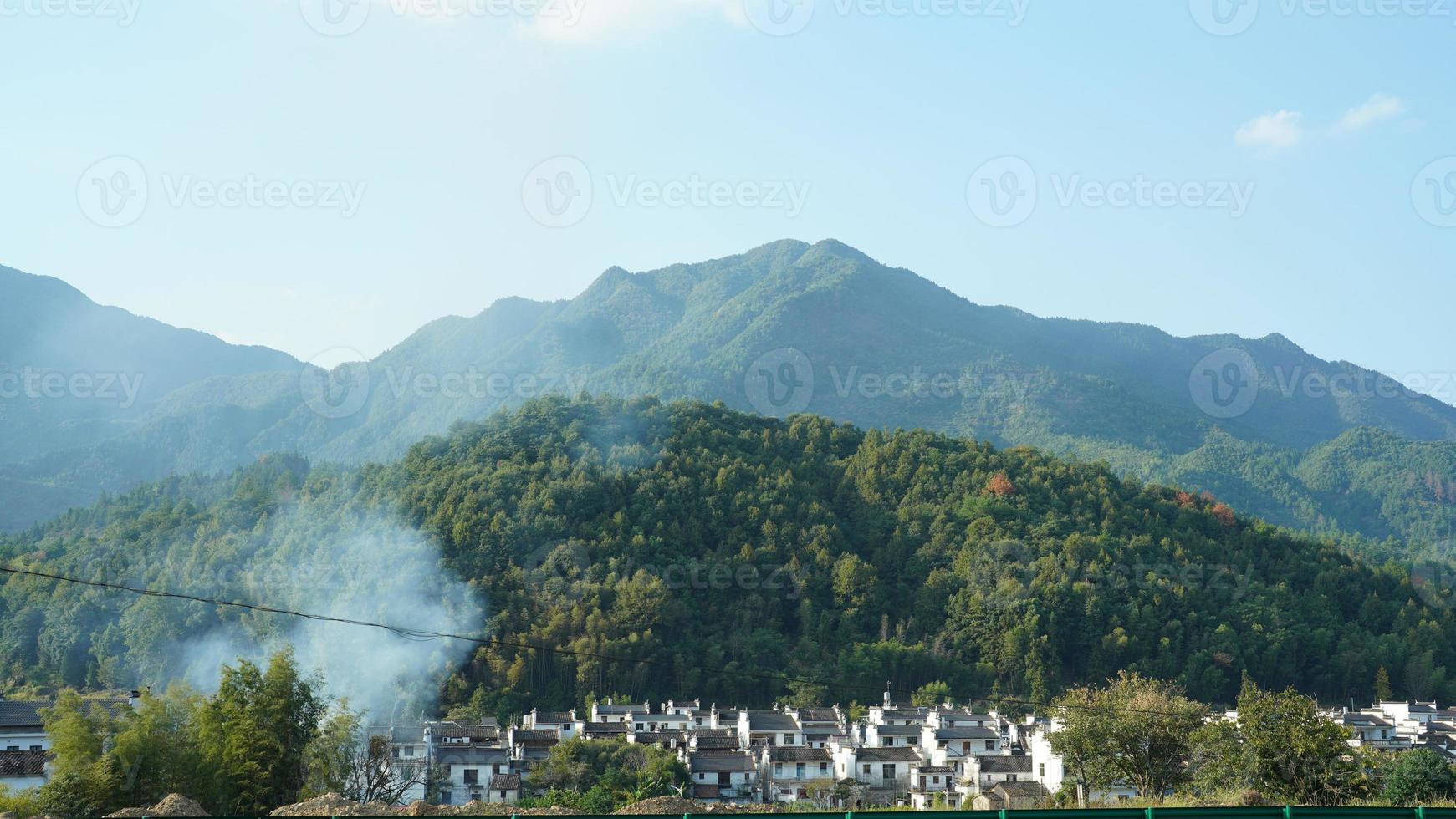 The beautiful traditional Chinese village view with the classical architecture and fresh green trees as background photo