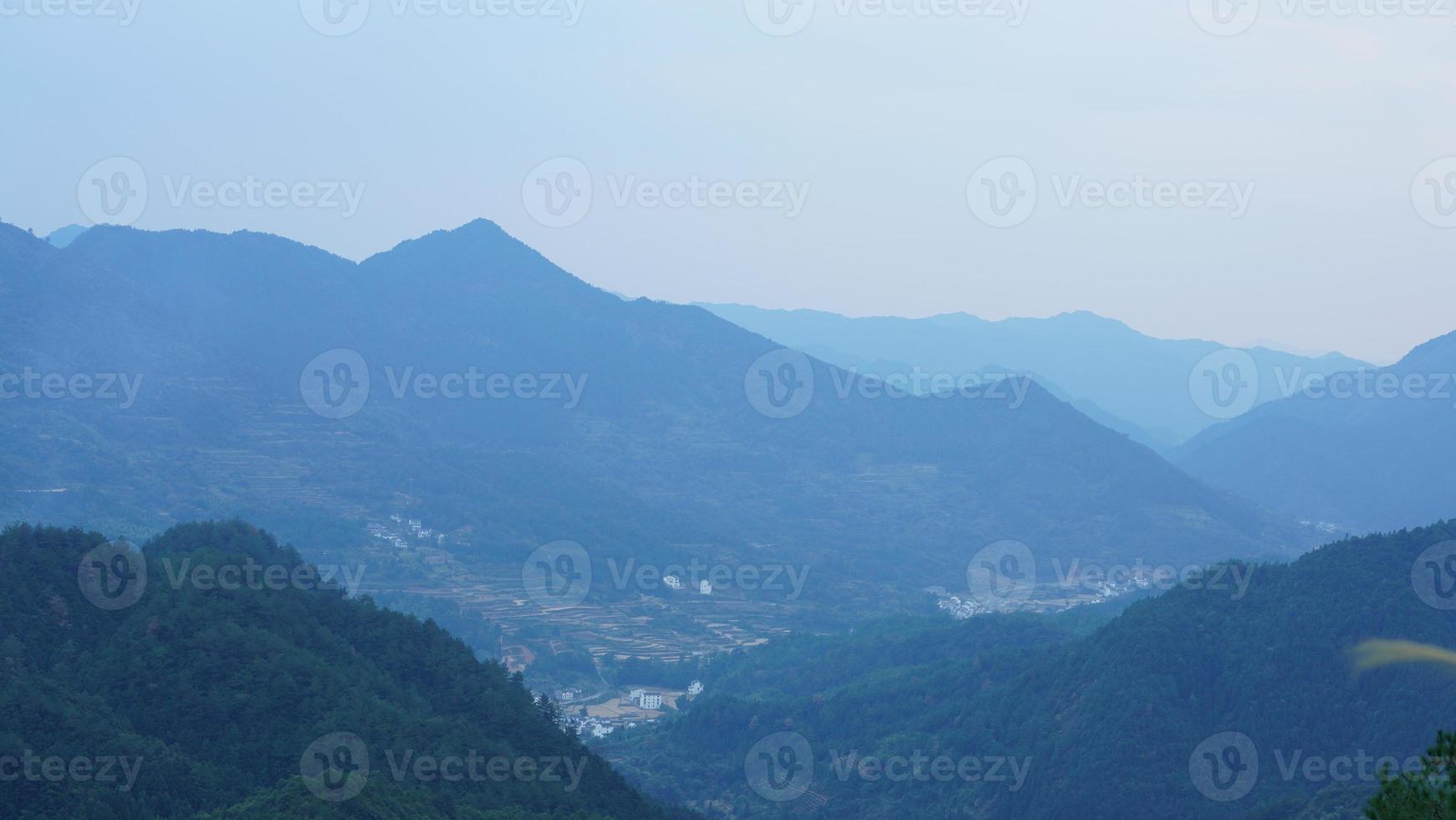The beautiful traditional Chinese village view with the classical architecture and fresh green trees as background photo