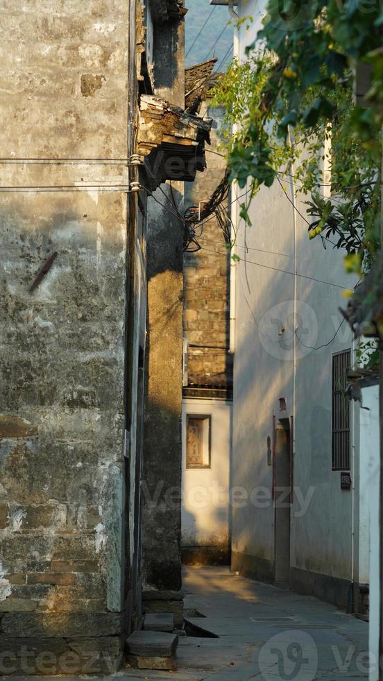 The beautiful traditional Chinese village view with the classical architecture and fresh green trees as background photo