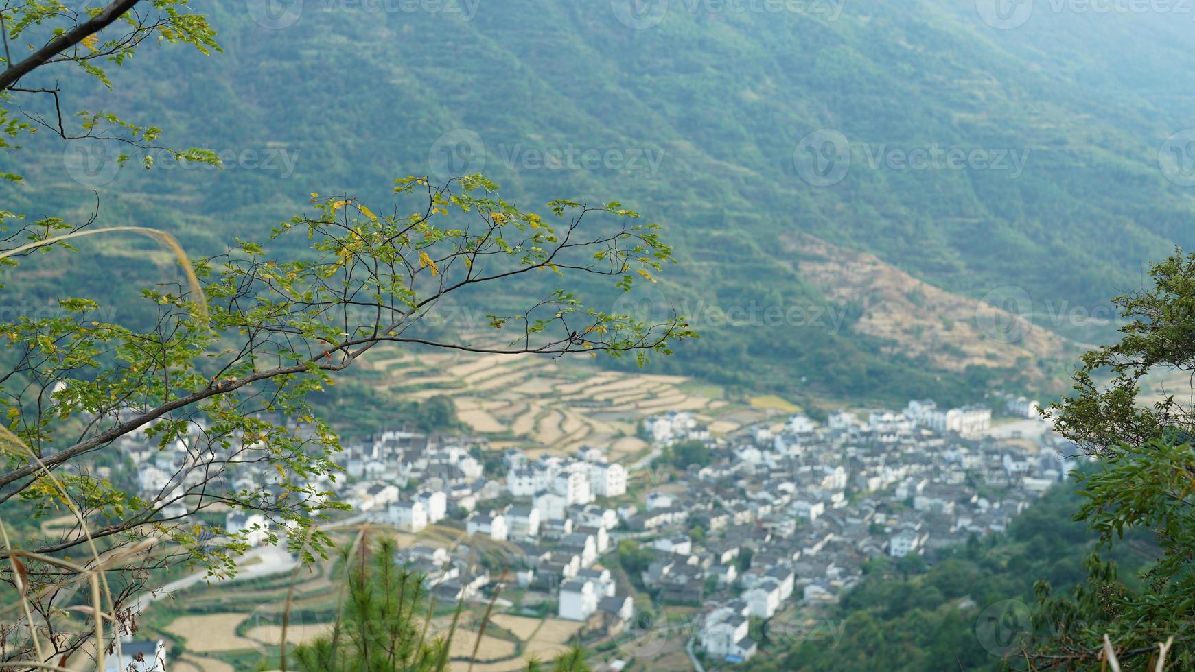 The beautiful traditional Chinese village view with the classical architecture and fresh green trees as background photo